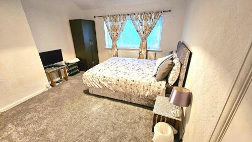 a bedroom with a bed and a window at Mo's home in Tilbury