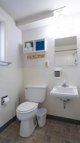 a bathroom with a toilet and a sink at RAD Hostel in Colorado Springs