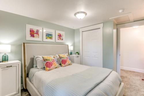 a bedroom with a bed with pillows on it at Rexburg Escape with Fenced Yard and Covered Patio! in Rexburg