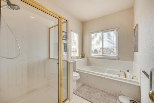 a bathroom with a tub and a toilet and a sink at Large Colorado Springs Home with View of Pikes Peak! in Pikeview