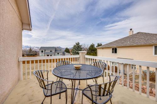 a patio with a table and chairs on a balcony at Large Colorado Springs Home with View of Pikes Peak! in Pikeview