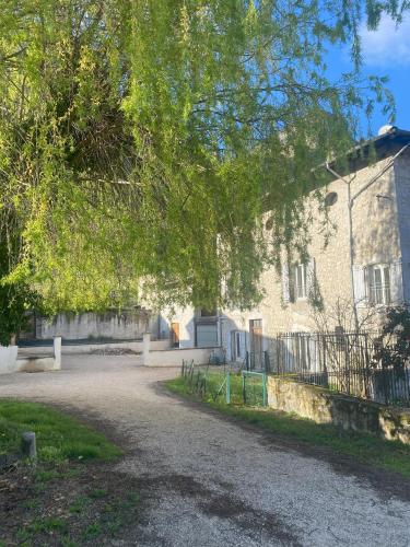 a building with a tree in front of it at Chambres de la ferme du Brocey in Crolles