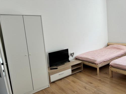 a bedroom with a bed and a tv on a cabinet at Adel Kaldekirche in Essen