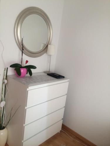 a white dresser with a mirror on top of it at D&E Apartments in Vienna