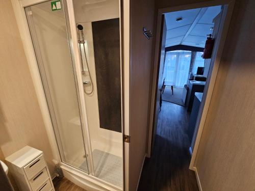 a walk in shower in a bathroom with a mirror at Rockley Park, The Poplars in Lytchett Minster