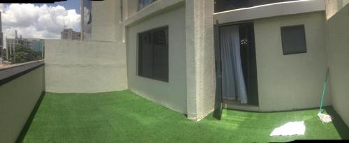 a balcony with green grass on the side of a building at maasaifari elite in Nairobi