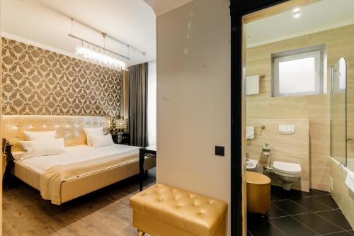 a hotel room with a bed and a bathroom at Weekend Boutique Hotel in Chişinău
