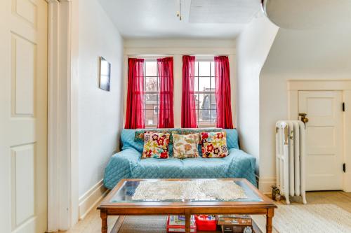 a living room with a blue couch and red curtains at Cozy Niagara Falls Cottage with Gas Grill and Patio! in Niagara Falls