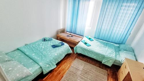 a room with two beds and a table in it at Apartman SONJA in Trebinje