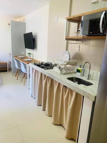 um balcão de cozinha com um lavatório e um fogão em Doce Lar Hospedagem em Morro de são Paulo AP completo com cozinha em Cairu