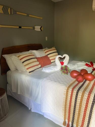 a bedroom with two swans on a bed at Villa Xodó in Fernando de Noronha