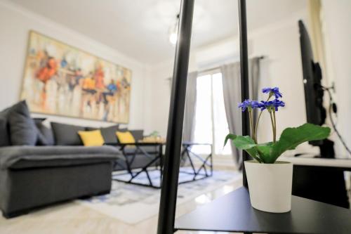 a living room with a couch and a table with a plant at Cozy apartment New Cairo in New cairo