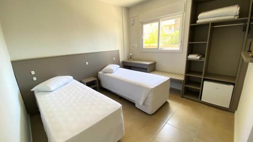 a small room with two beds and a window at ÓPER SMART HOTEL in Santa Maria