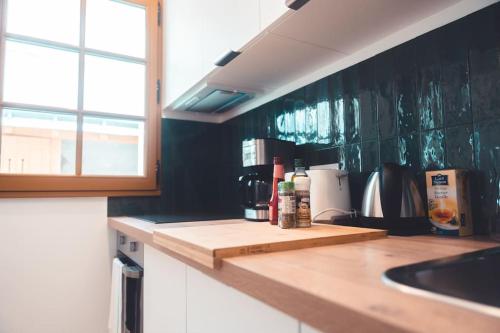 a kitchen with a wooden counter top and a sink at Le Colimaçon in Tours
