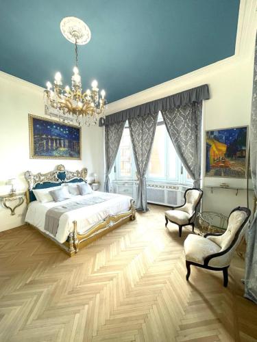 a bedroom with a bed and a chandelier at Stile Libero Guest House in Turin