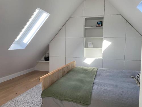 a bedroom with a bed and a skylight at The Conservatory in Lokeren