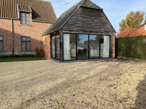 an extension to a house with a large window at The Conservatory in Lokeren