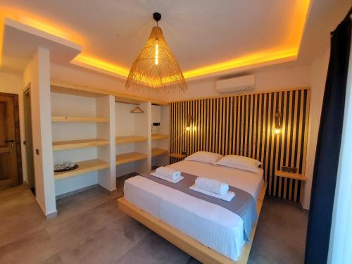ein Schlafzimmer mit einem großen Bett und einem Kronleuchter in der Unterkunft Palamut Butik Otel in Datca