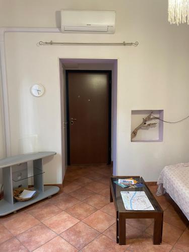 a living room with a door and a table at Dimora Ghirlandaio in Florence