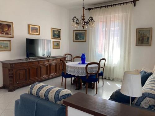a living room with a table and a tv at Casa Rina in Livorno