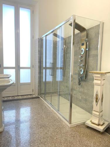 a glass shower in a bathroom with a sink at Stile Libero Guest House in Turin