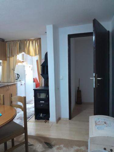 a kitchen with a door open to a living room at Dolores in Tešanj