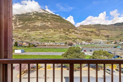 a view from a balcony with mountains in the background at Duplex cosy aux bains de Saillon in Saillon