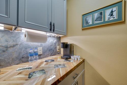 a kitchen with a counter with water bottles on it at Central Texarkana Studio Rental with Railroad Views! in Texarkana