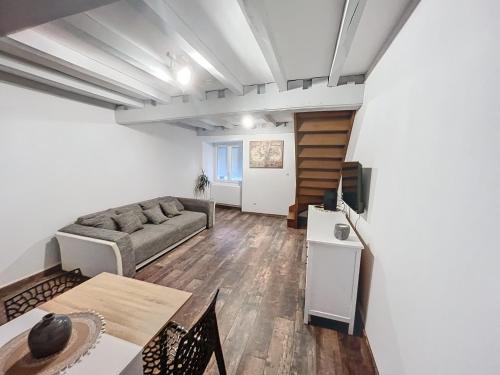 a living room with a couch and a table at Appartement au centre-ville in Chaumont