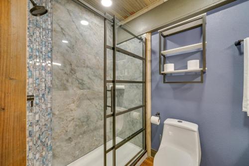 a bathroom with a toilet and a glass shower at Pet-Friendly Texarkana Studio in The Historic 1894 in Texarkana