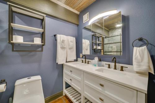 a bathroom with a white sink and a mirror at Pet-Friendly Texarkana Studio in The Historic 1894 in Texarkana