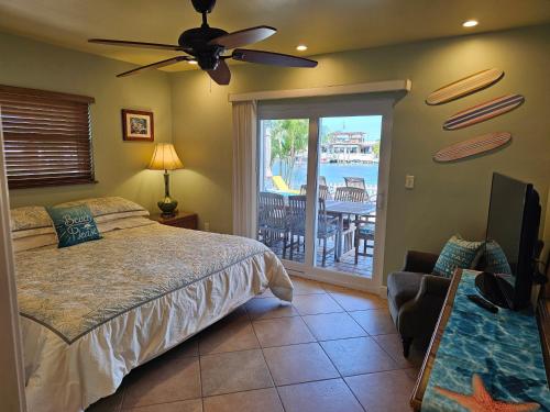 a bedroom with a bed and a view of the ocean at IRB SURF HOUSE Waterfront Oasis+ Sunshine +Fun Kayaks in Clearwater Beach