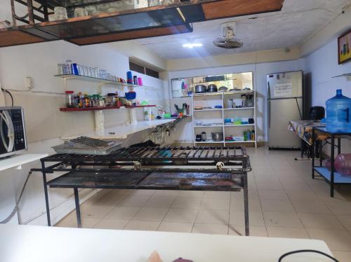 a kitchen with a table in the middle of a room at Hostal Xiinbal Valladolid in Valladolid