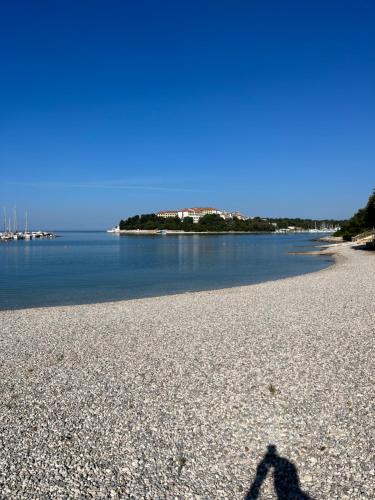 a shadow of a person walking on a beach at Adriatic View in Pješčana Uvala 