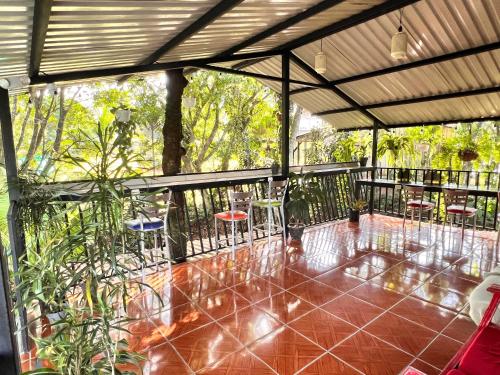 a patio with chairs and tables on a balcony at Rio Danta in Fortuna