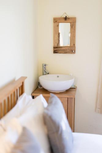 a bathroom with a white sink and a mirror at Oak House in Mid Wales with Log Burner By Seren Short Stays in Machynlleth
