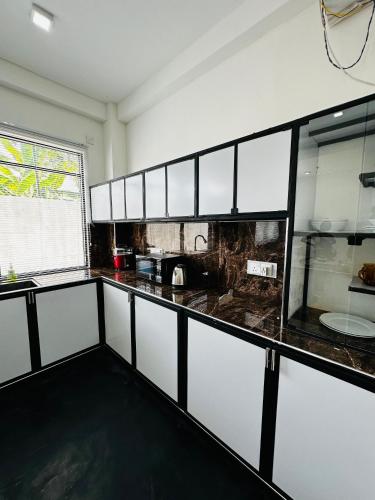 a kitchen with black and white counter tops at Large 4 Bedroom Spacious Apartment in Nugegoda, Colombo in Nugegoda
