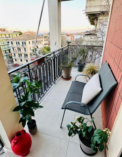 a balcony with a chair and a laptop on it at Elli & Klairi Apartment in Ágios Rókkos