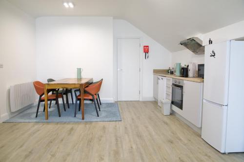 a kitchen with a table and chairs and a refrigerator at Mary St House 3B in Dublin