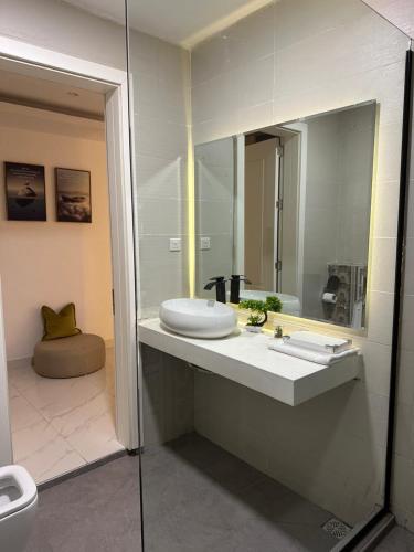 a bathroom with a sink and a mirror at Numdor Apartments By The Bond in Port Harcourt