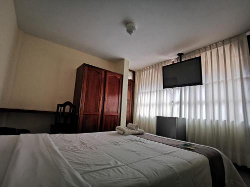 Un dormitorio con una cama con un osito de peluche. en Hotel Bombonaje, en Rioja