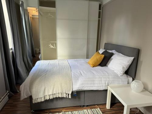 a bedroom with a bed with a mirror and a table at Flat In London's Primrose Hill in London