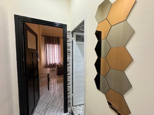 a mirror on a wall next to a hallway at Casablanca Central Suites - Casa Port in Casablanca