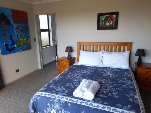 a bedroom with a bed with two towels on it at Executive Home in Kaikoura