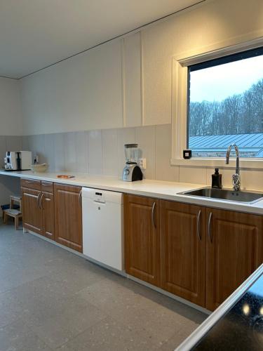 una cocina vacía con fregadero y ventana en Big villa by the lake en Olofström