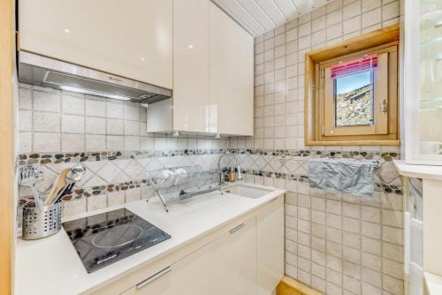 a kitchen with a sink and a window at Résidence Lot b - Pièces 271 in Tignes