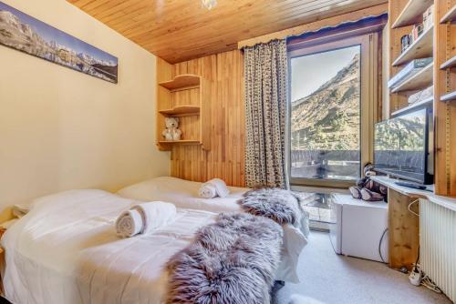 a bedroom with a bed and a large window at Résidence Lot b - Pièces 271 in Tignes
