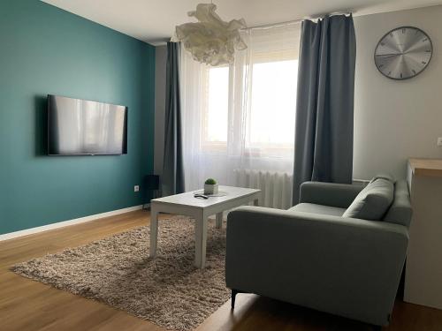 a living room with a couch and a table at Cozy Urban Retreat in Panevėžys