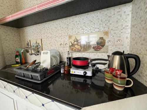 a kitchen counter with a stove and a tea kettle at Casablanca Central Suites - Casa Port in Casablanca