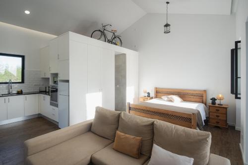 a living room with a couch and a bed at Herdade do Lameiro - Sea & Mountain Retreat in Ribeira Grande